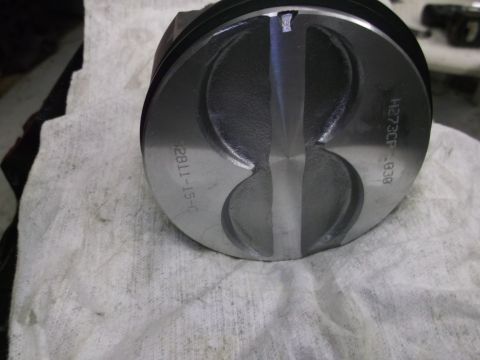 1987 Ford Mustang - Close-up of a piston showing stamped part numbers and manufacturing details.