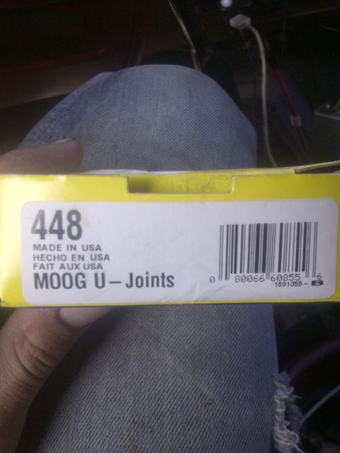 1995 Ford Bronco - A yellow box labeled MOOG U-Joints is held in front of denim fabric.