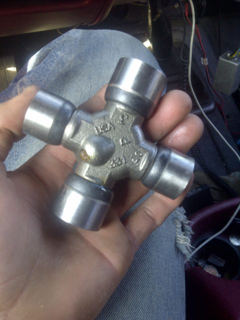 1995 Ford Bronco - A universal joint part is held in a hand, with visible markings including 'USA' and '331'.