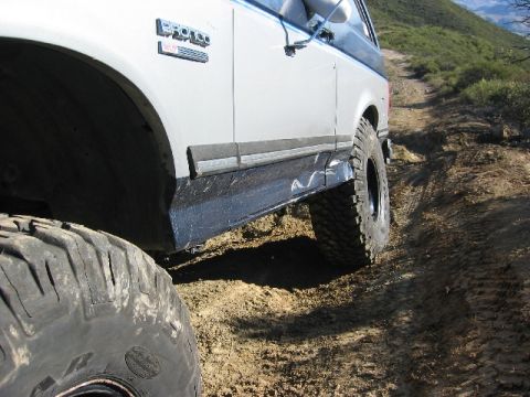 1989 Ford Bronco - Off-roading in a 1989 Ford Bronco on a dusty, uphill trail.