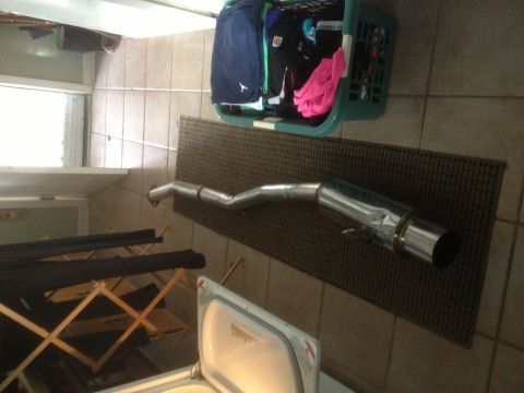 1996 Ford Bronco - Exhaust pipe is shown in a laundry room setting, not installed on a vehicle.