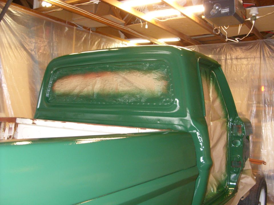 Green 1967 Ford F-250 cab being painted, rear 3/4 view