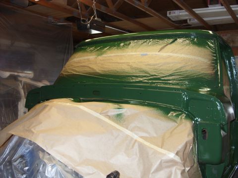 1967 Ford F-250 - A truck cab, likely from the 1950s, is undergoing a paint job in a workshop.