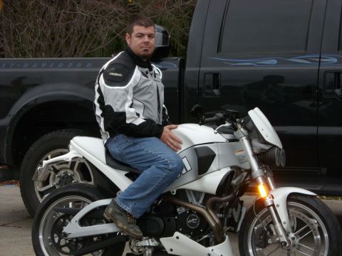 2003 Buell Lightning w/Fairing - A man sits on a white Buell motorcycle parked in front of a black Ford F-Series truck.