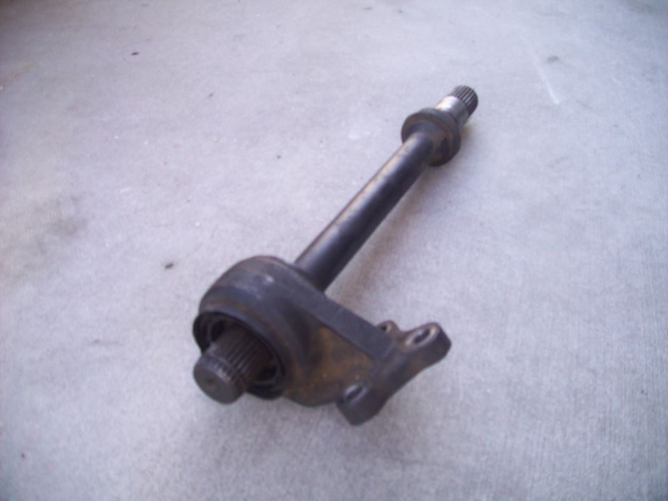 Automotive suspension part with splined shaft and mounting flange