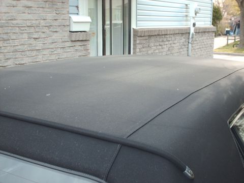 1991 Mercury Grand Marquis - Close-up view of a car's fabric roof, showing its texture and construction details.