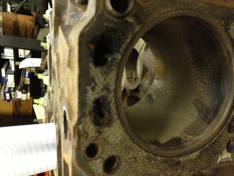 1987 Ford Ranger - Engine block cylinder bore detail, with parts storage in the background.