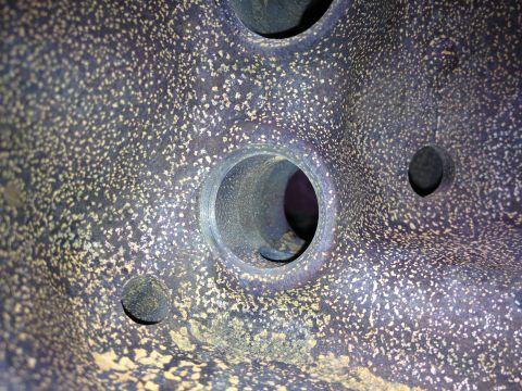1987 Ford Ranger - This is a close-up view of a cast metal component, likely from an engine, showing its textured surface and openings.