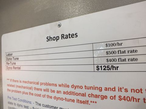 2003 Ford Crown Victoria - close-up of a posted dyno-shop rates sign, not a vehicle technical document.
