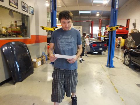 2003 Ford Crown Victoria - Person holds a Dynojet Research dyno graph from Racers Edge Tuning showing power and torque lines