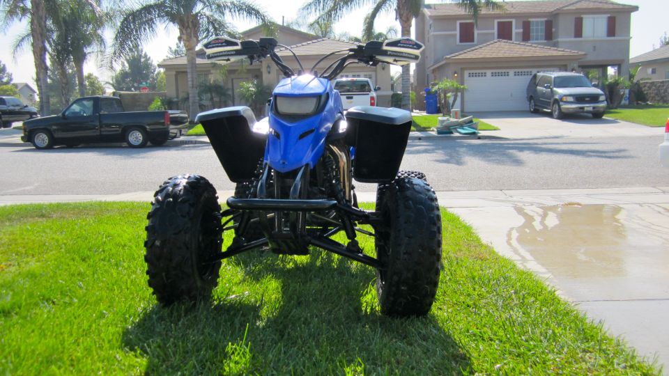 Blue ATV front view on grass
