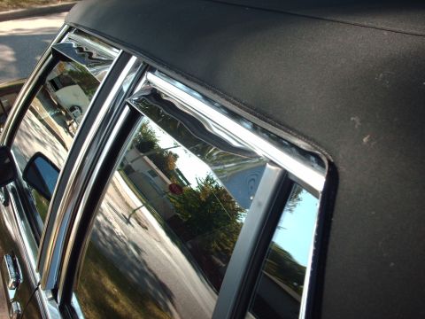 1991 Mercury Grand Marquis - Close-up of a car's roofline and windows, showing chrome accents and rain guards.