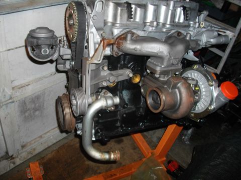 1989 Ford Probe - Engine assembly on a stand, a turbocharger and timing belt components.