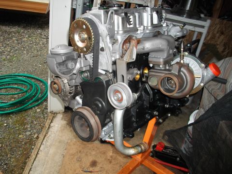 1989 Ford Probe - This engine assembly features a turbocharger and is mounted on an orange engine stand.