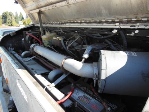 1979 Ford Bronco - Engine bay details showing air intake and battery.