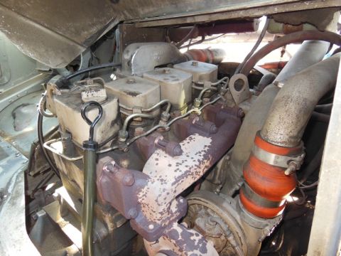 1979 Ford Bronco - Close-up view of a vehicle's engine compartment, showing various mechanical components.