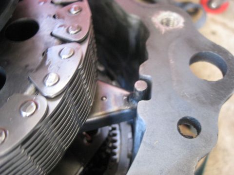 1994 Ford Bronco - Transfer case chain and gears shown with a metal bracket, likely during a repair or rebuild.