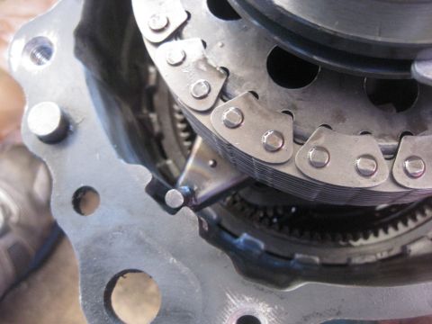 1994 Ford Bronco - Internal components of a vehicle's transfer case, including a chain and toothed gears.