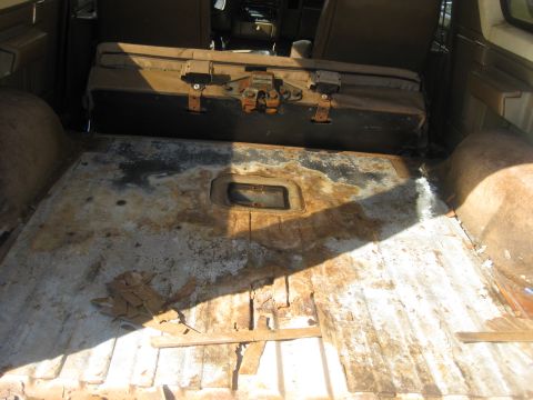 1994 Ford Bronco - Cargo area with carpet removed. Any water that leaked in would gather in the recess for the rear seat latch.