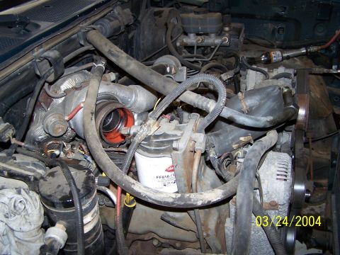 1986 Ford Bronco - Close-up view of an engine bay, focusing on the turbocharger and associated components.