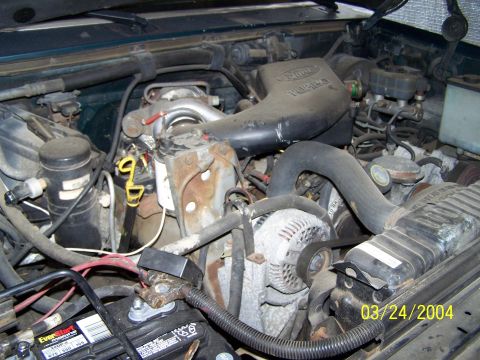 1986 Ford Bronco - Close-up view of the engine compartment, showing the Ford 7.3L IDI Turbo Diesel engine and its components.