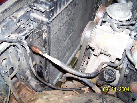 1986 Ford Bronco - Engine bay components including radiator and AC compressor are visible in this close-up photo.