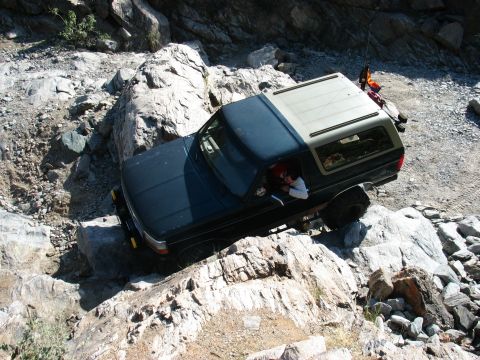 1994 Ford Bronco - This 1994 Ford Bronco is shown tackling a challenging off-road course on a sunny day.