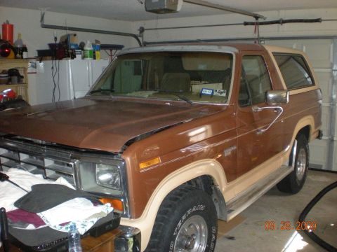 1986 Ford Bronco - This 1986 Ford Bronco is seen in a garage, showing its two-tone brown and tan paint scheme.