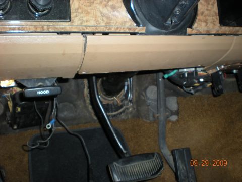 1986 Ford Bronco - A close-up view of the interior of a vehicle shows the dashboard, pedals, and exposed wiring.