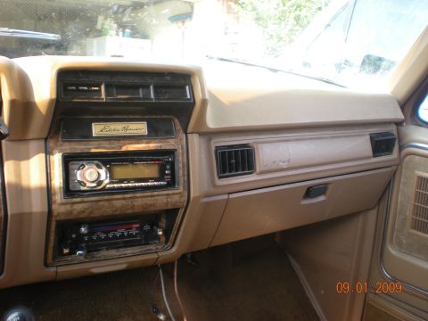 1986 Ford Bronco - Interior view of a 1986 Ford Bronco, showing the dashboard with Eddie Bauer badging and aftermarket audio equipment.