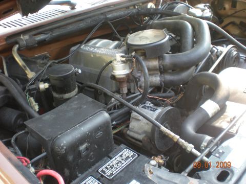 1986 Ford Bronco - A close-up view of the engine compartment, showing various mechanical parts and hoses.