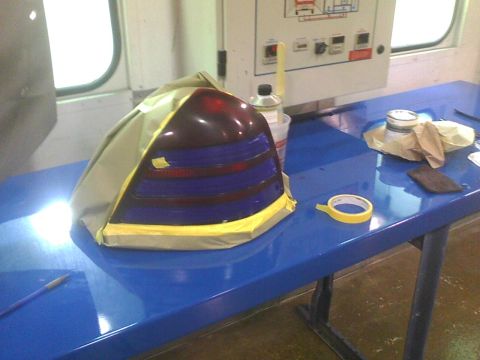 2003 Ford Crown Victoria - A vehicle taillight assembly is prepared for modification on a blue workbench.