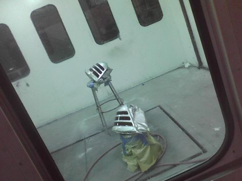2003 Ford Crown Victoria - Car grilles are being painted in a spray booth.