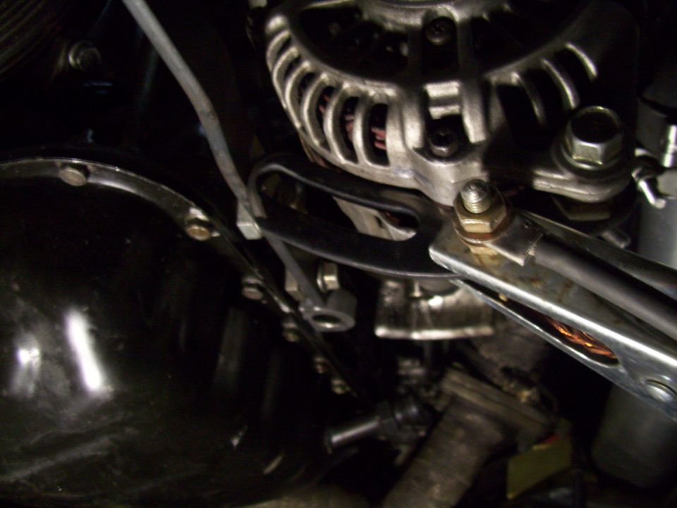 Close-up of car alternator and black engine component