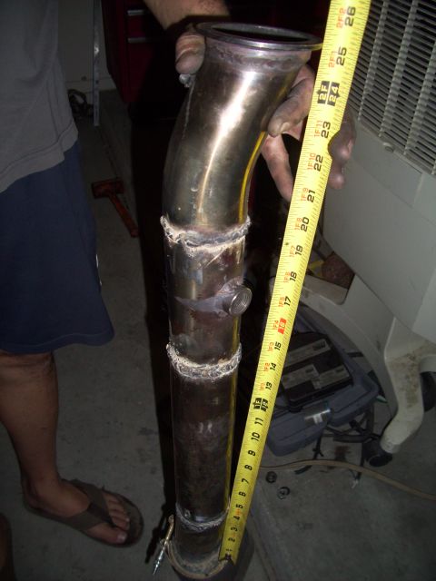 1995 Ford Probe - A custom exhaust pipe is measured, with a person's legs visible in the background.