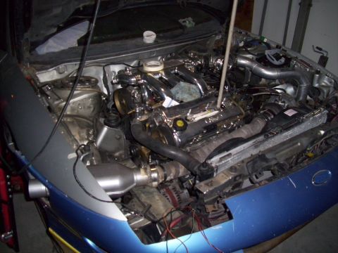 1995 Ford Probe - Car engine bay with a chrome intake manifold, showing custom modifications and wiring.