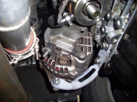 1995 Ford Probe - This image shows an alternator and associated engine components, not a 1995 Ford Probe.