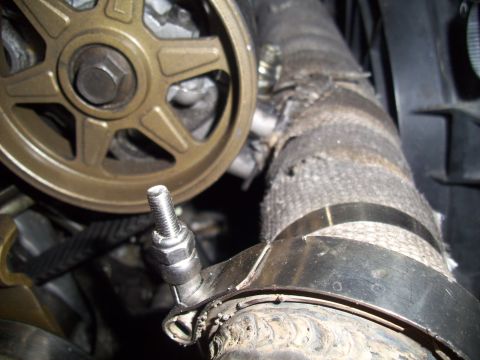 1995 Ford Probe - Engine bay detail showing a pulley and a heat-wrapped hose secured by a clamp.