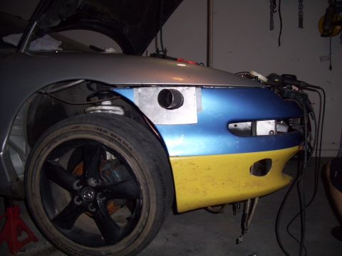 1995 Ford Probe - Front fender of a car undergoing modifications, showing custom metalwork and paint.