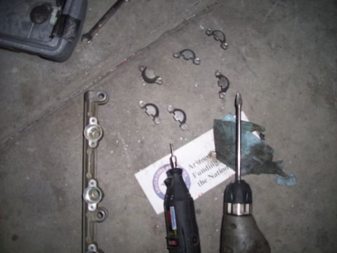 1995 Ford Probe - Various automotive parts and tools are laid out on a concrete surface, suggesting a repair or maintenance task.
