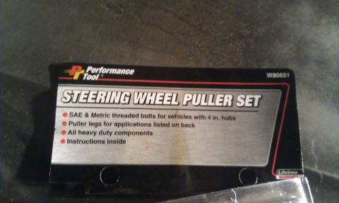 1991 Ford Festiva - Packaging for a steering wheel puller set, indicating it is for vehicles with 4-inch hubs and includes heavy-duty components.