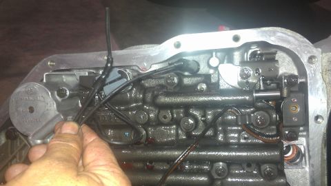 1973 Chevrolet Camaro - Close-up of an automatic transmission valve body with internal components and wiring visible.
