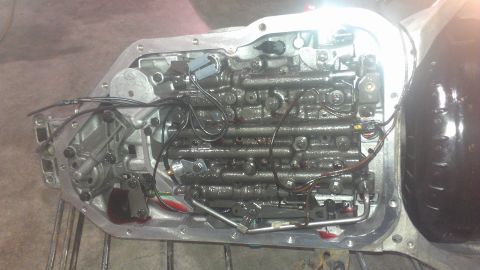1973 Chevrolet Camaro - Close-up view of an automatic transmission valve body, showing internal components and fluid lines.
