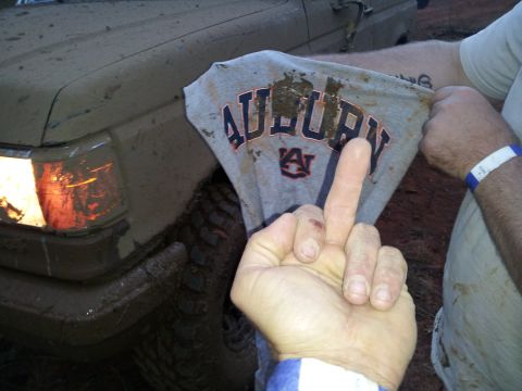 1986 Ford Bronco - This 1986 Ford Bronco is covered in mud, but its headlights are on.