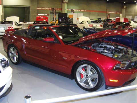 2007 Ford Mustang - Red 2007 Ford Mustang convertible on display at an indoor car show.