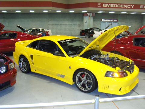 2007 Ford Mustang - A bright yellow Saleen Mustang is displayed with its hood open, revealing the engine compartment.