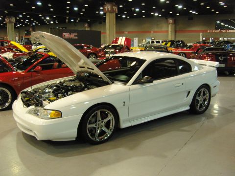 2007 Ford Mustang - White 1994 Ford Mustang coupe displayed with its hood open at a car show.