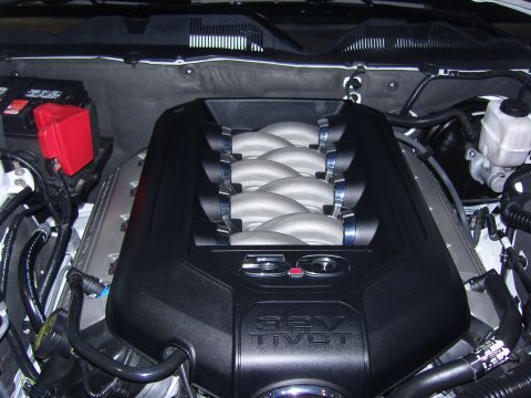 2007 Ford Mustang - Close-up of an engine cover displaying "5.0" and "32V Ti-VCT" markings.