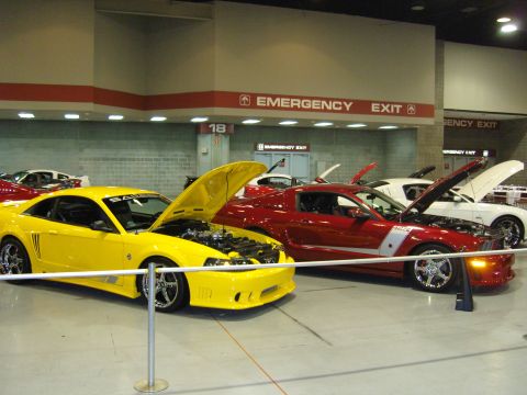 2007 Ford Mustang - A yellow 2007 Ford Mustang, identified as a Saleen model, is displayed with its hood open at a car show.
