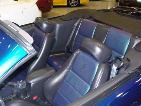2007 Ford Mustang - Interior view of a 2007 Ford Mustang convertible, showing the blue and black leather seats.